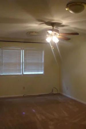 a view of a room that has a window and a chandelier
