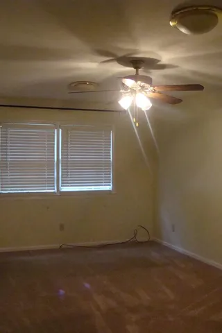 a view of a room that has a window and a chandelier