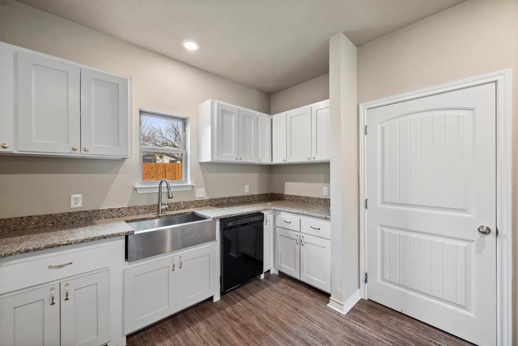 2877 Conveyor Drive, Unit B Burleson, TX 76028 - Photo 10 of 22 Kitchen featuring black dishwasher, dark wood-type flooring, white cabinets, recessed lighting, and light stone counters