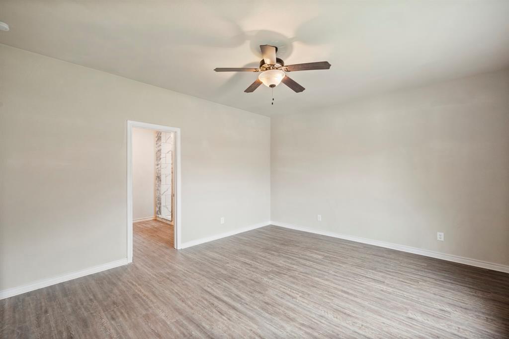 2877 Conveyor Drive, Unit B Burleson, TX 76028 - Photo 12 of 22 Spare room featuring wood finished floors and a ceiling fan