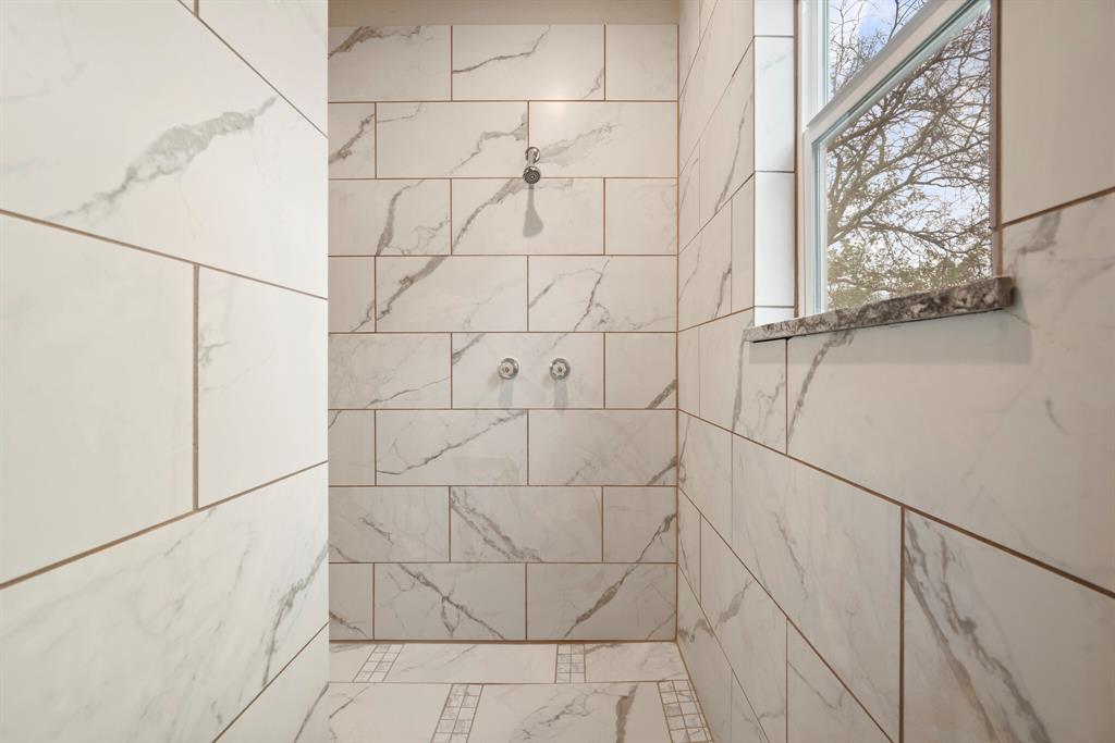 2877 Conveyor Drive, Unit B Burleson, TX 76028 - Photo 15 of 22 Bathroom featuring a tile shower