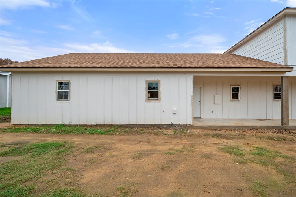 2877 Conveyor Drive, Unit B Burleson, TX 76028 - Photo 19 of 22 Rear view of house with a shingled roof