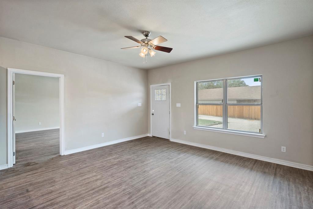 2877 Conveyor Drive, Unit B Burleson, TX 76028 - Photo 5 of 22 Spare room featuring ceiling fan and wood finished floors