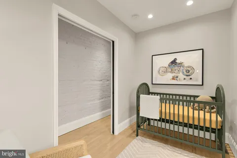 a view of a hallway with a couch and a dining table