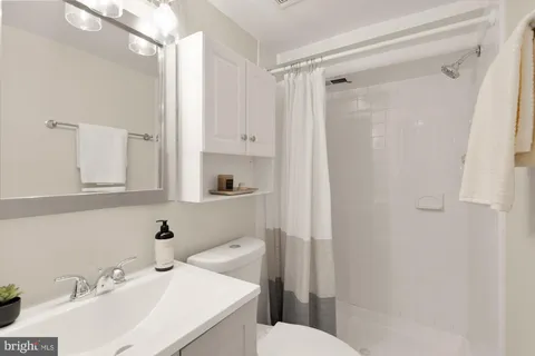 a bathroom with a sink toilet and shower