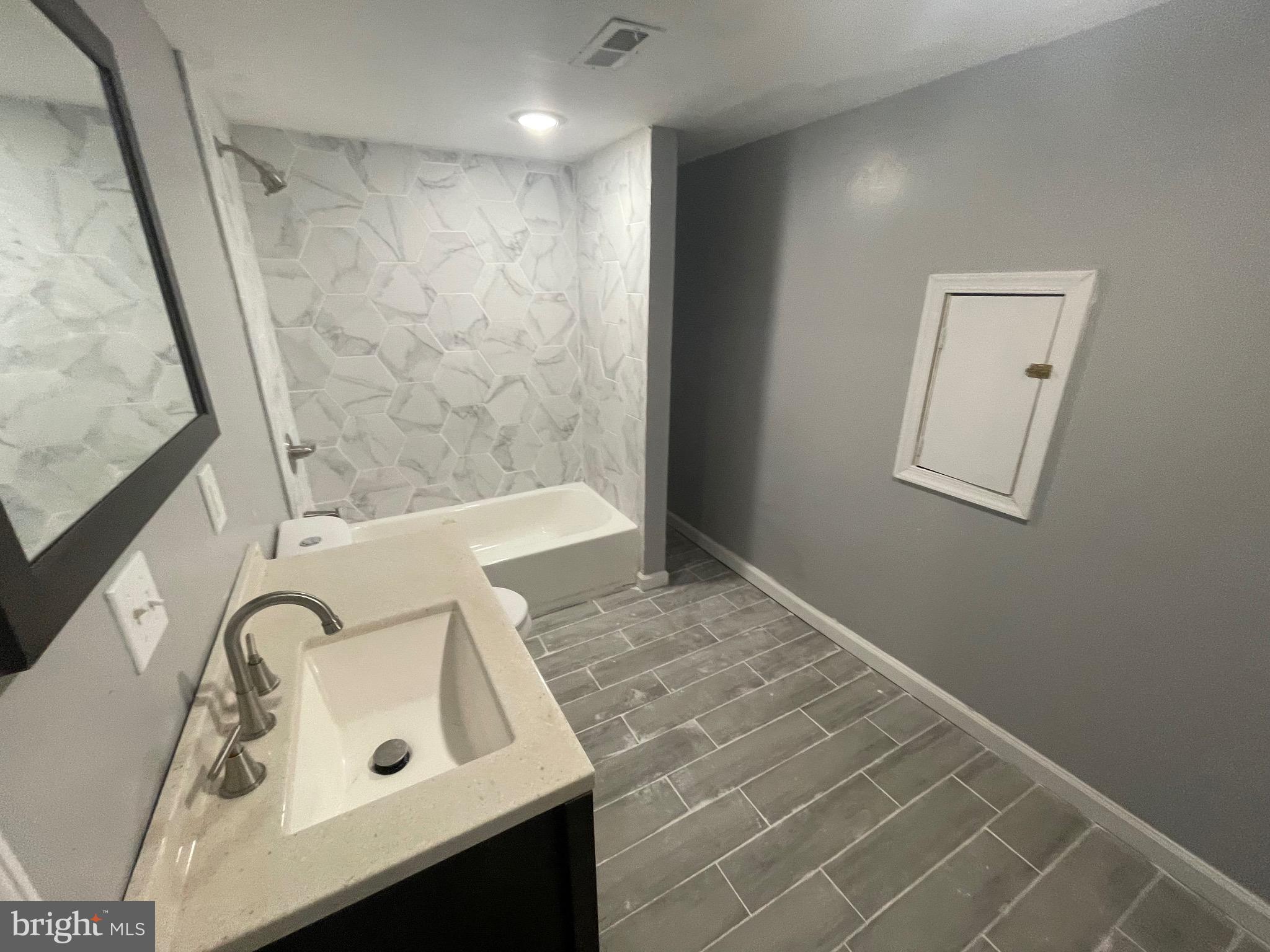 6416 Overbrook Avenue Philadelphia, PA 19151 - Photo 12 of 18 a bathroom with a sink and a tub