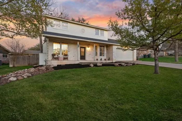 a front view of a house with a yard table and chairs