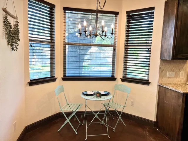 a view of a room that has a table and chair