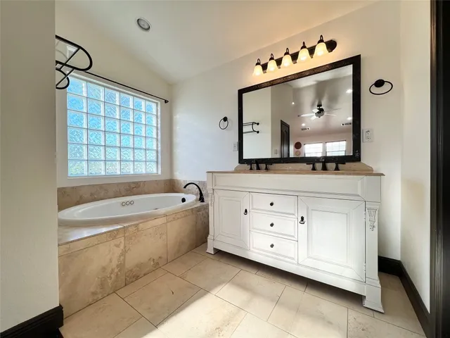 a bathroom with a bathtub and a window