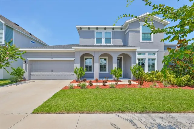 a front view of house with yard and green space