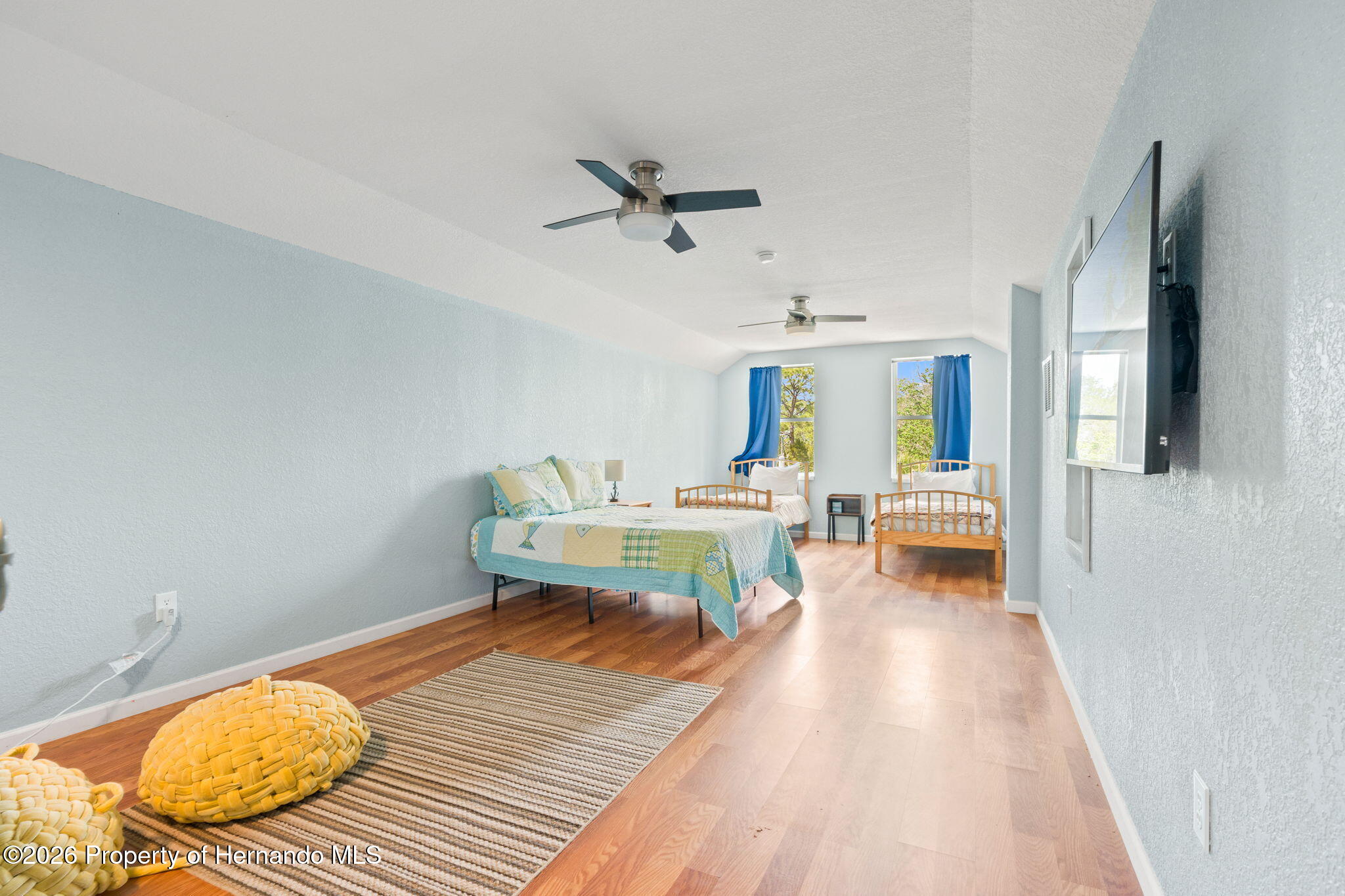 1566 Indian Bay Road Spring Hill, FL 34607 - Photo 37 of 56 a living room with furniture and a wooden floor