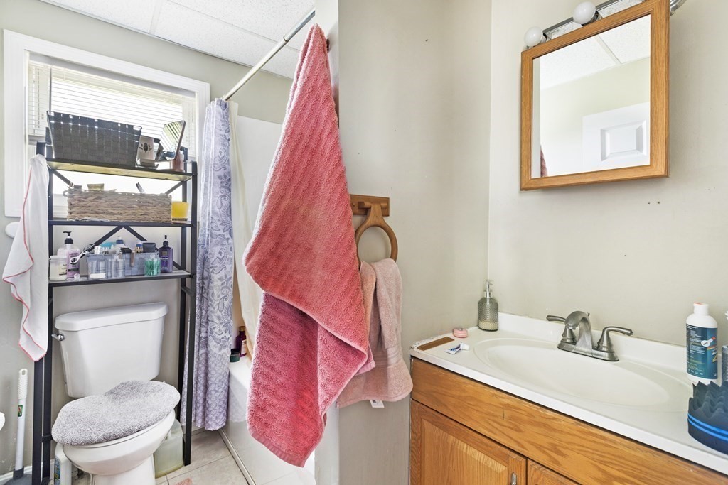 185 Stevens Street Fall River, MA 02721 - Photo 14 of 28 a bathroom with a sink vanity mirror and toilet