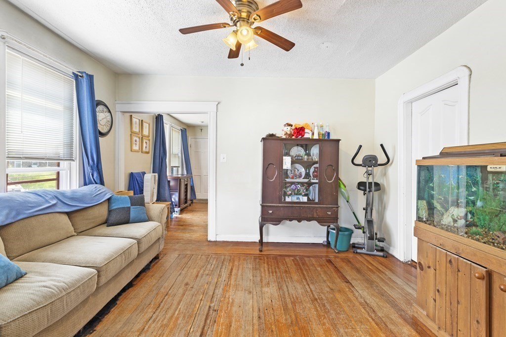 185 Stevens Street Fall River, MA 02721 - Photo 22 of 28 a living room with furniture and a floor to ceiling window