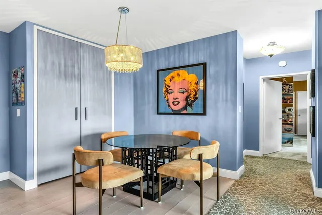 a dining room with furniture and chandelier