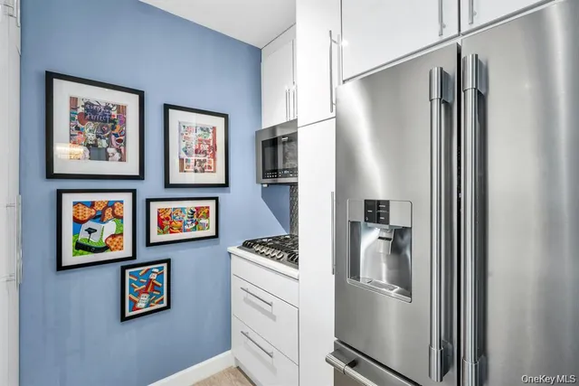 a kitchen with stainless steel appliances a refrigerator and a stove
