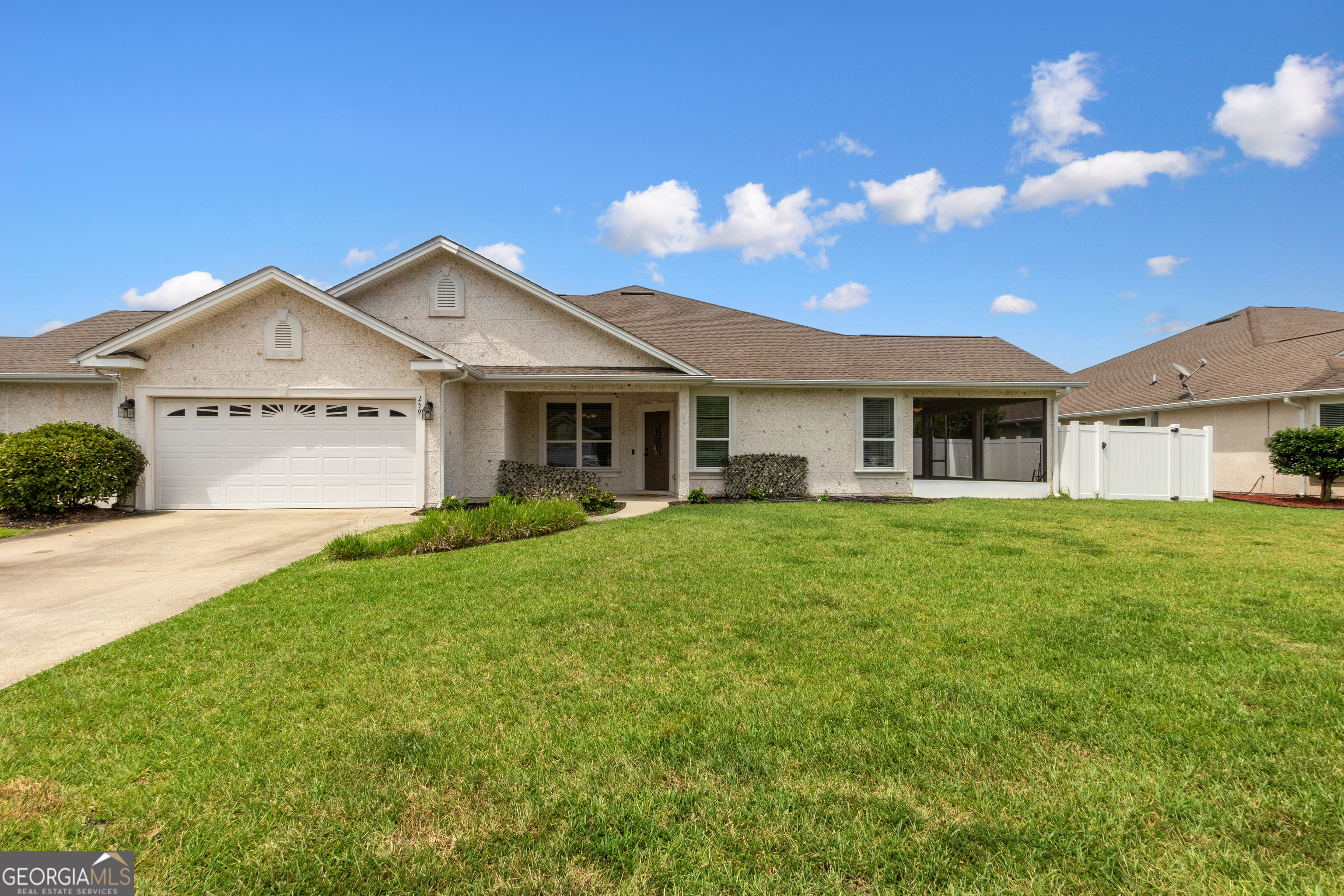 259 Laurel Landing Boulevard Kingsland, GA 31548 - Photo 1 of 43 a front view of a house with a garden and yard