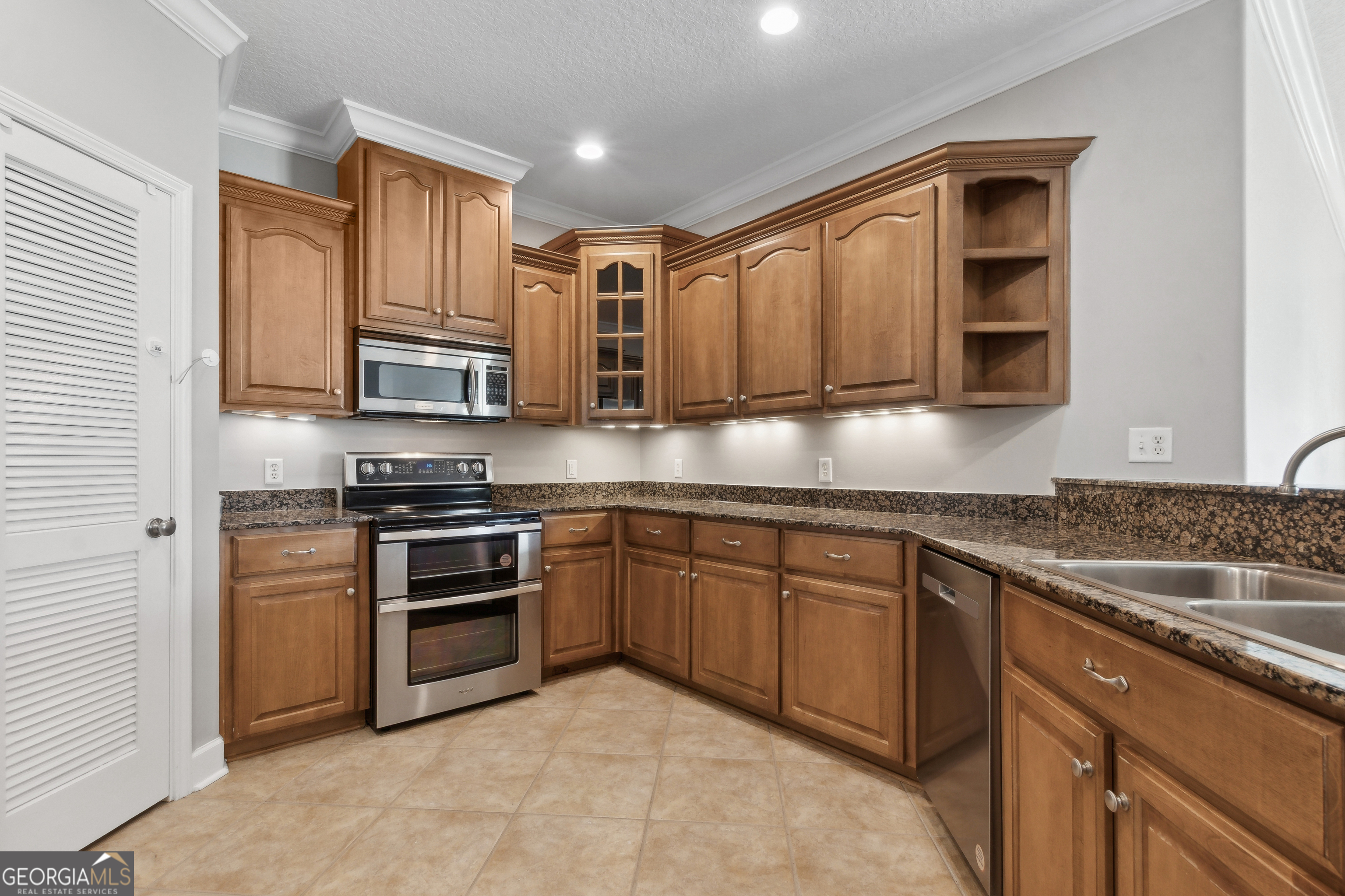 259 Laurel Landing Boulevard Kingsland, GA 31548 - Photo 11 of 43 a kitchen with stainless steel appliances granite countertop a stove sink microwave and cabinets