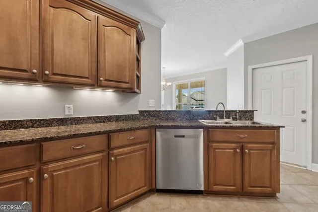 a kitchen with granite countertop white cabinets and sink