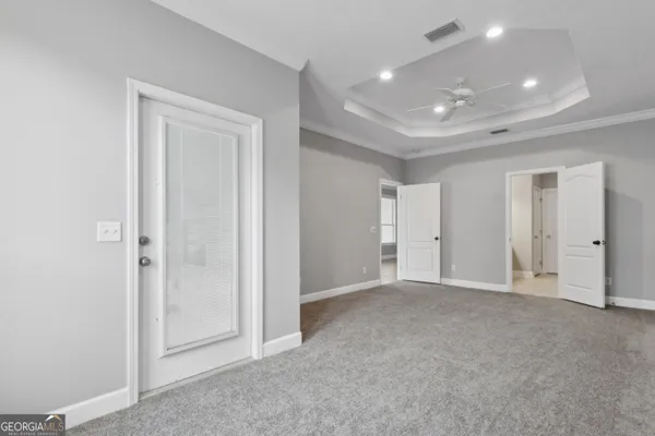 an empty room with closet and a bathroom