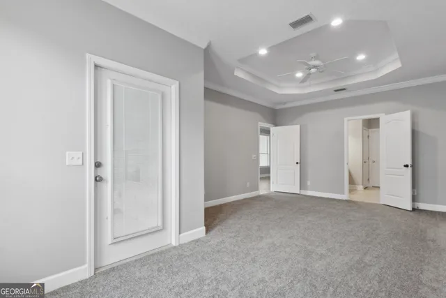 an empty room with closet and a bathroom