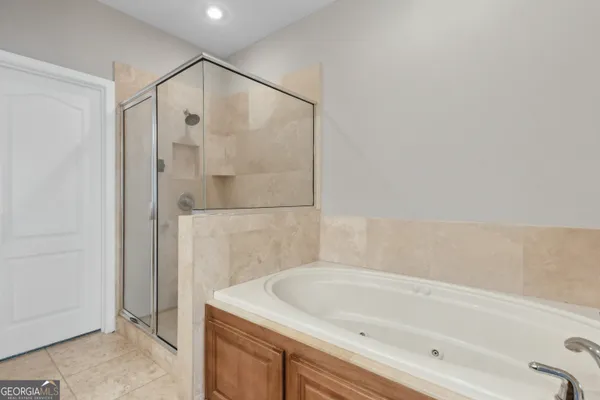 a bathroom with a tub and shower