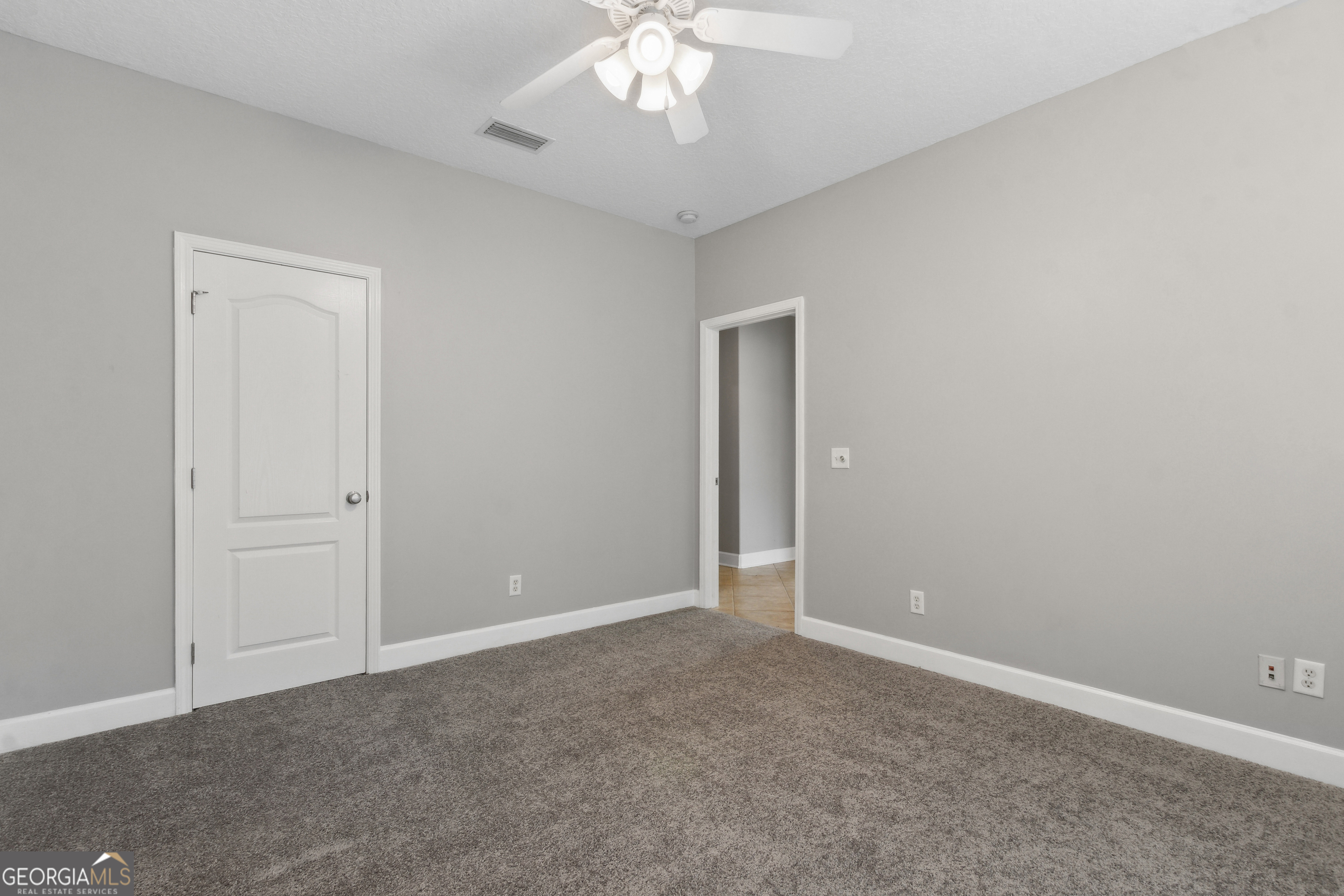 259 Laurel Landing Boulevard Kingsland, GA 31548 - Photo 21 of 43 an empty room with a chandelier fan and closet area