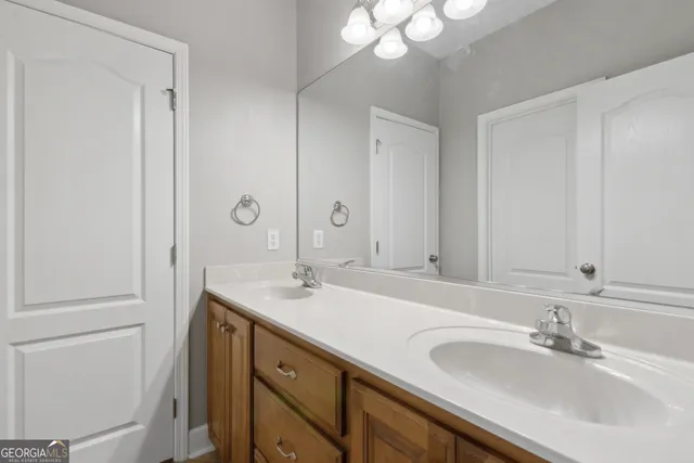 a bathroom with a sink double vanity and a mirror