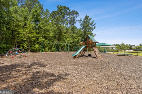 a view of a park with swings and slides