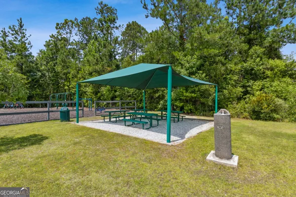 a view of a yard with furniture and a fire pit