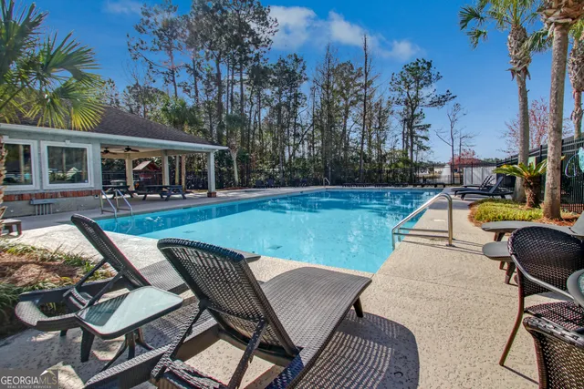 a view of a house with backyard patio and sitting area
