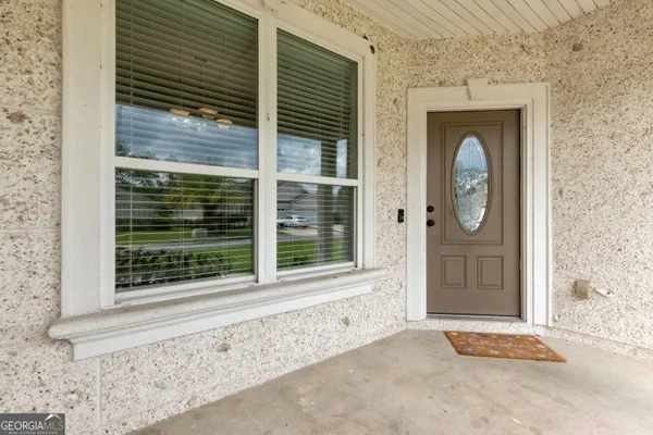 a front view of a house with a large window and door