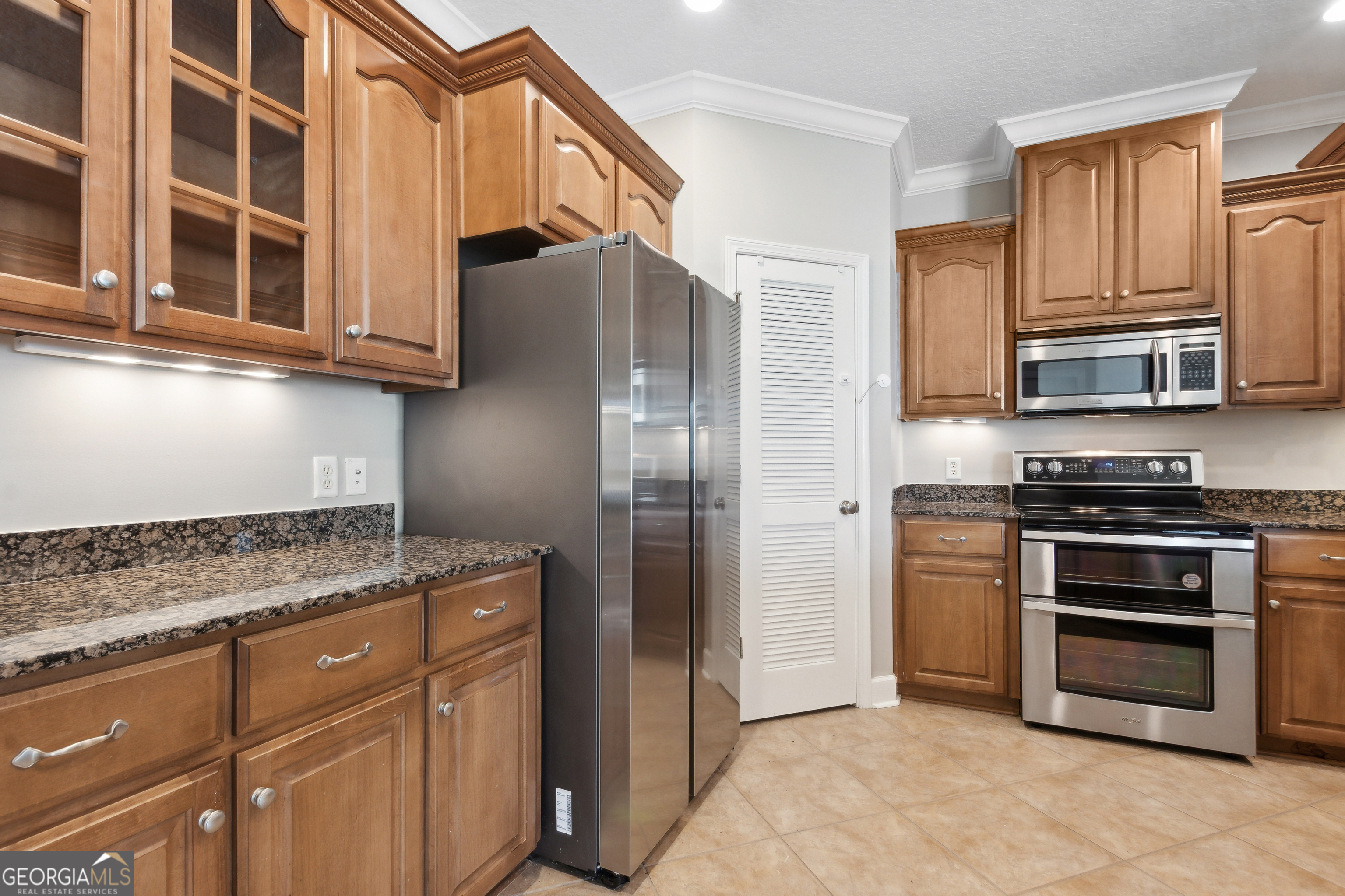 259 Laurel Landing Boulevard Kingsland, GA 31548 - Photo 10 of 43 a kitchen with stainless steel appliances granite countertop a refrigerator and a stove top oven