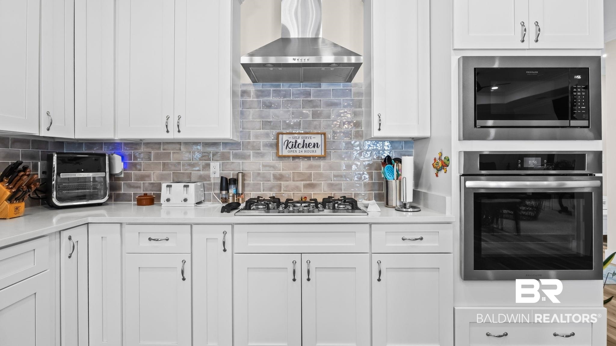 8013 Carmel Circle Foley, AL 36535 - Photo 11 of 49 Kitchen featuring white cabinets, stainless steel appliances, backsplash, and light stone counters