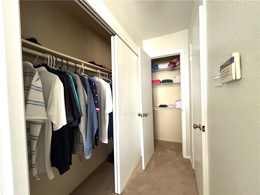 840 Cliff Drive, Unit 4 Portland, TX 78374 - Photo 19 of 32 a view of walk in closet with clothes and shoes