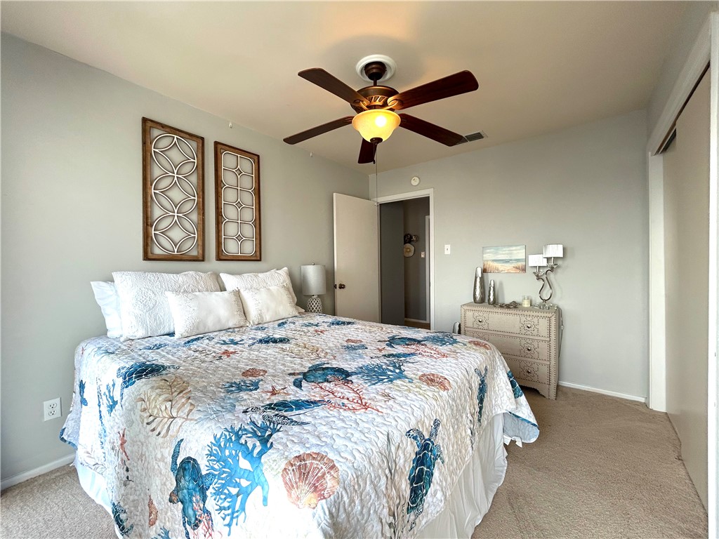 840 Cliff Drive, Unit 4 Portland, TX 78374 - Photo 22 of 32 a bedroom with a bed and a chandelier