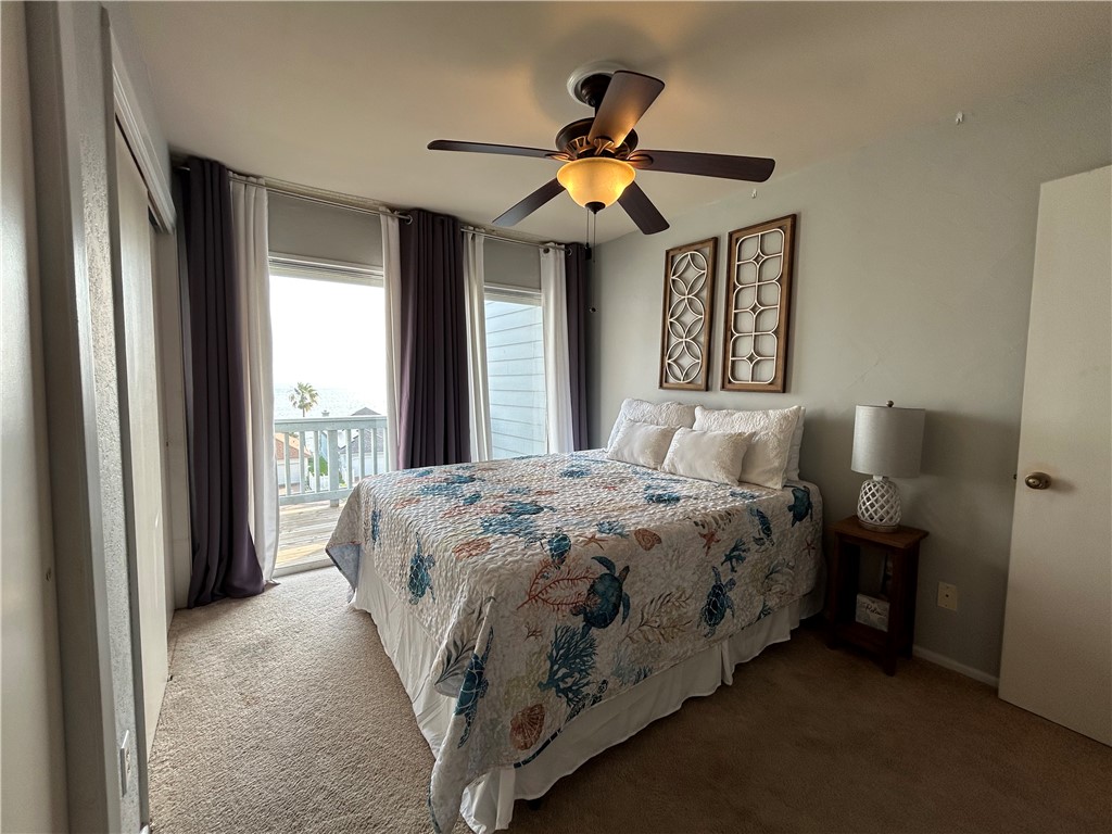 840 Cliff Drive, Unit 4 Portland, TX 78374 - Photo 23 of 32 a bedroom with a bed and a chandelier