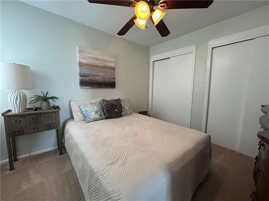 840 Cliff Drive, Unit 4 Portland, TX 78374 - Photo 25 of 32 a bedroom with a bed and a chandelier