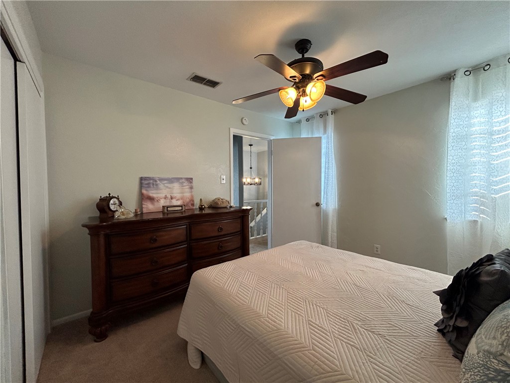 840 Cliff Drive, Unit 4 Portland, TX 78374 - Photo 26 of 32 a bedroom with a bed and a chandelier