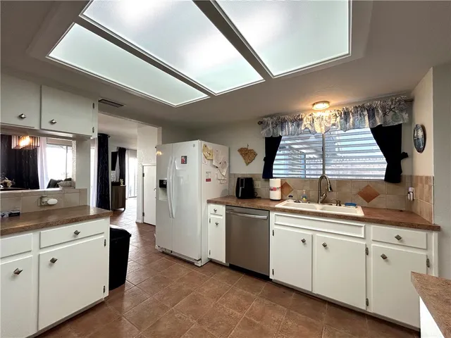 a kitchen with a white cabinets and counter top space