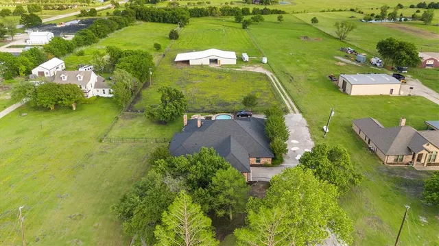an aerial view of a house with a yard basket ball court and outdoor seating