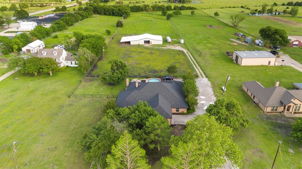 an aerial view of a house with a yard basket ball court and outdoor seating