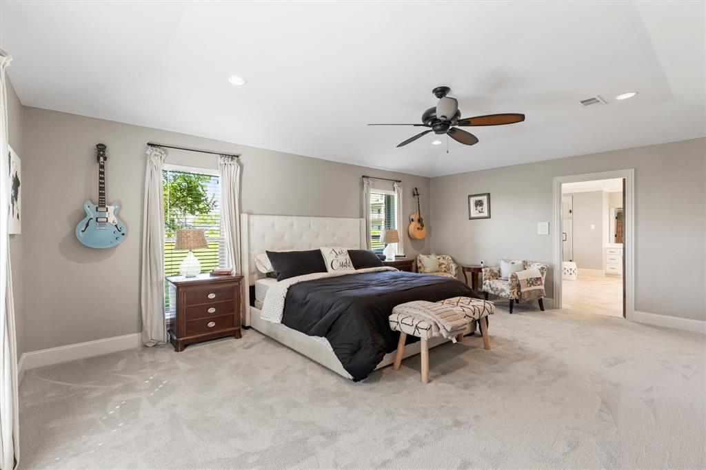 161 Pullen Road McLendon-Chisholm, TX 75032 - Photo 15 of 39 a spacious bedroom with a bed and a chandelier