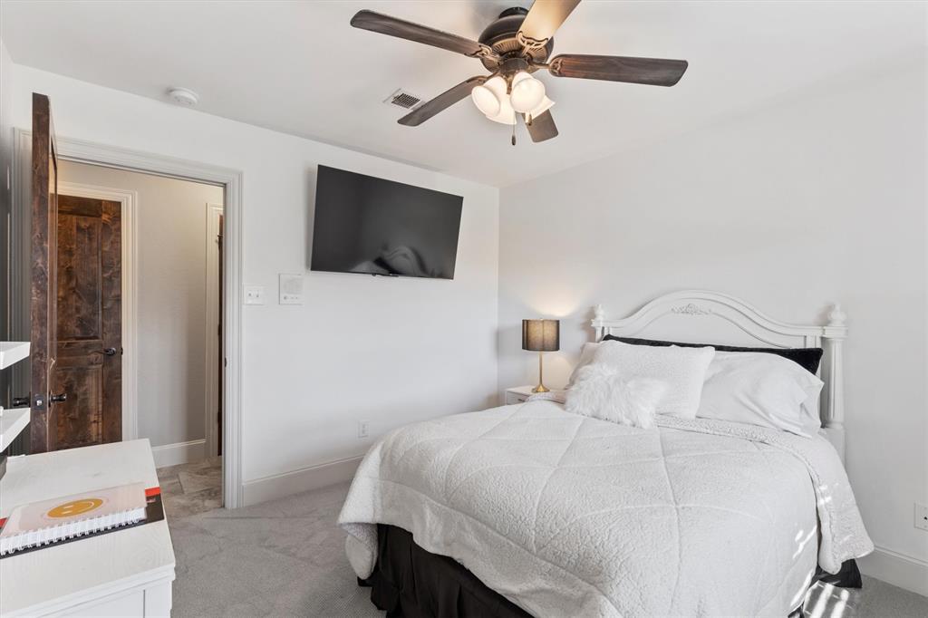 161 Pullen Road McLendon-Chisholm, TX 75032 - Photo 20 of 39 a bedroom with a bed and a flat screen tv