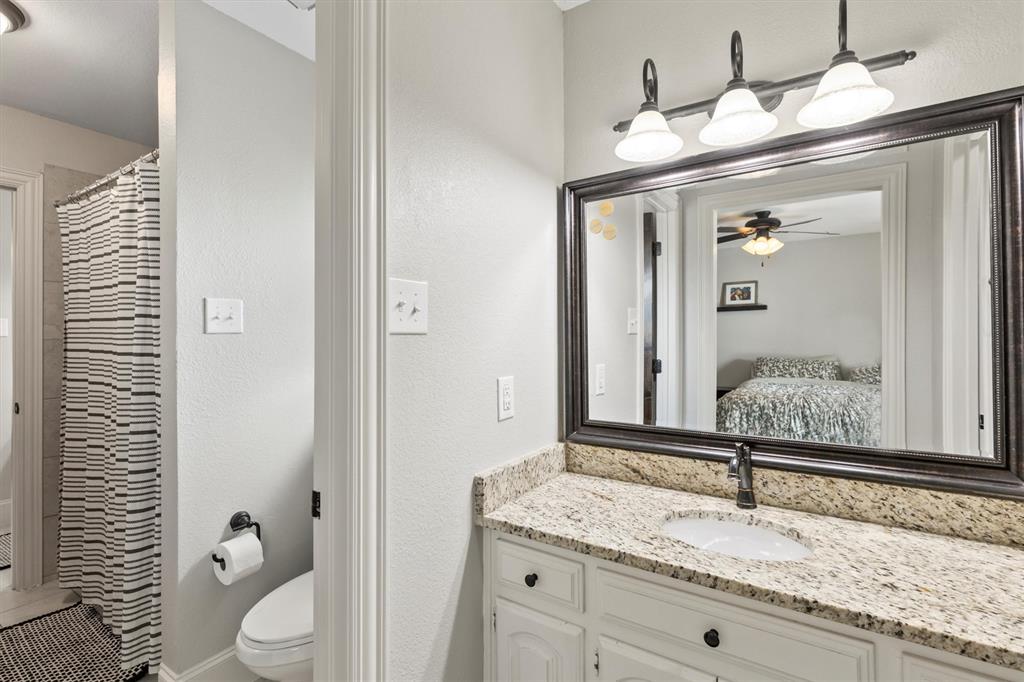 161 Pullen Road McLendon-Chisholm, TX 75032 - Photo 22 of 39 a bathroom with a granite countertop sink and a mirror