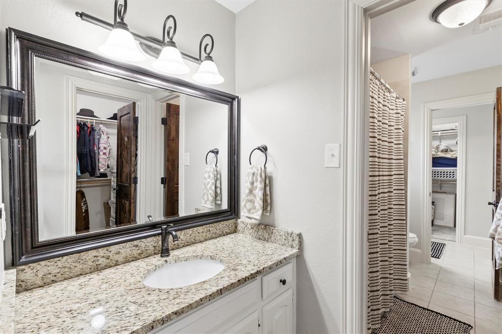 161 Pullen Road McLendon-Chisholm, TX 75032 - Photo 23 of 39 a bathroom with a granite countertop sink and a mirror