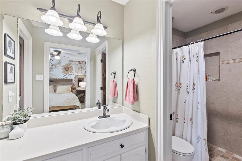 161 Pullen Road McLendon-Chisholm, TX 75032 - Photo 24 of 39 a bathroom with a sink vanity granite and a mirror
