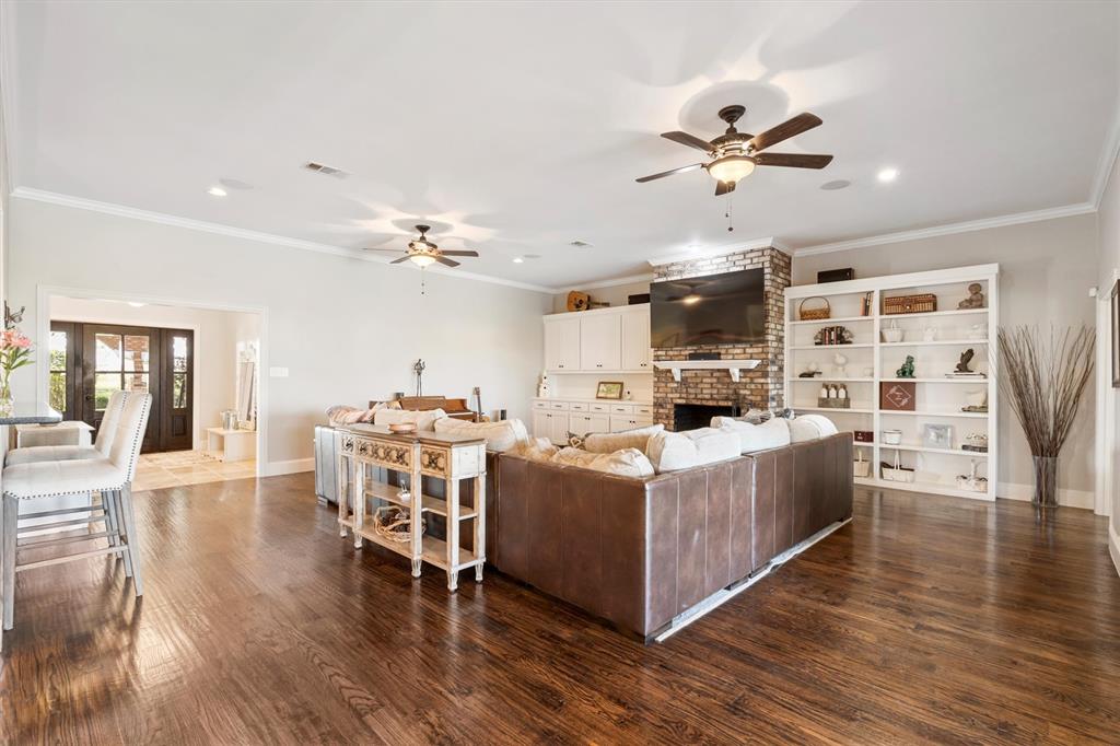 161 Pullen Road McLendon-Chisholm, TX 75032 - Photo 7 of 39 a living room with stainless steel appliances kitchen island granite countertop a table chairs and a refrigerator
