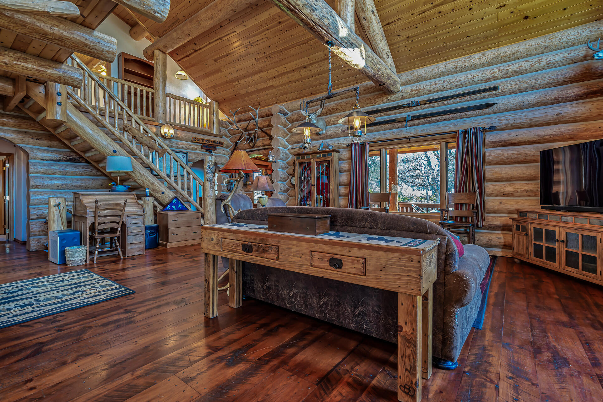 43007 Shoshoni Loop Fall River Mills, CA 96028 - Photo 27 of 87 a room with lots of wooden furniture and a chandelier