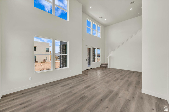 560 Aqua Cove St. George, UT 84790 - Photo 6 of 27 Unfurnished living room with a high ceiling, wood finished floors, and recessed lighting
