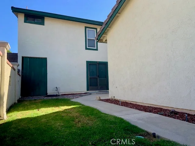 a house with potted plants in front of door